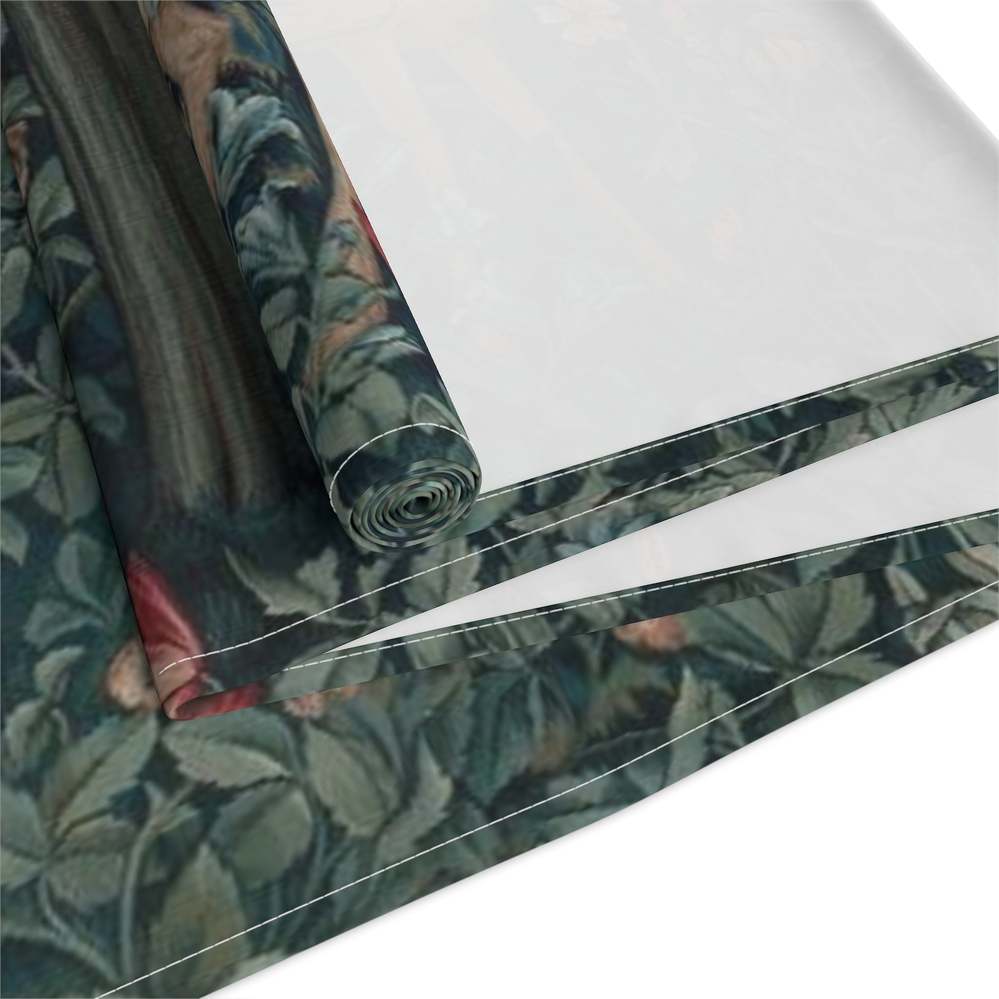 A table runner with a floral William Morris & Co pattern, featuring green leaves and pink flowers with a fox, dear and rabbit.