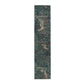 A table runner with a floral William Morris & Co pattern, featuring green leaves and pink flowers with a fox, dear and rabbit.