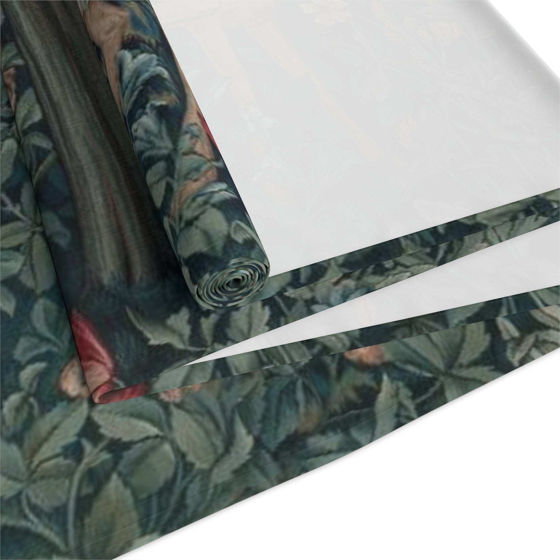 A table runner with a floral William Morris & Co pattern, featuring green leaves and pink flowers with a fox, dear and rabbit.