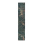 A table runner with a floral William Morris & Co pattern, featuring green leaves and pink flowers with a fox, dear and rabbit.