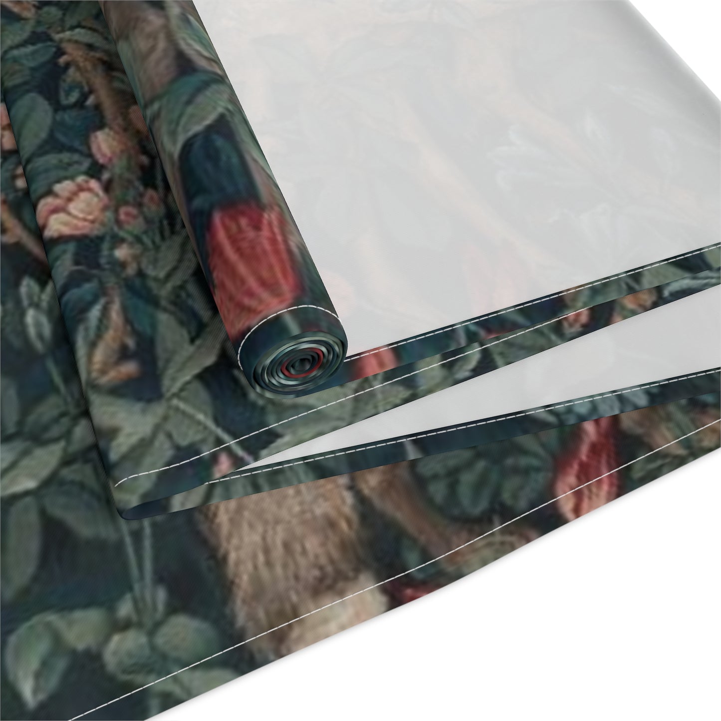 A table runner with a floral William Morris & Co pattern, featuring green leaves and pink flowers with a fox, dear and rabbit.