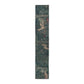 A table runner with a floral William Morris & Co pattern, featuring green leaves and pink flowers with a fox, dear and rabbit.