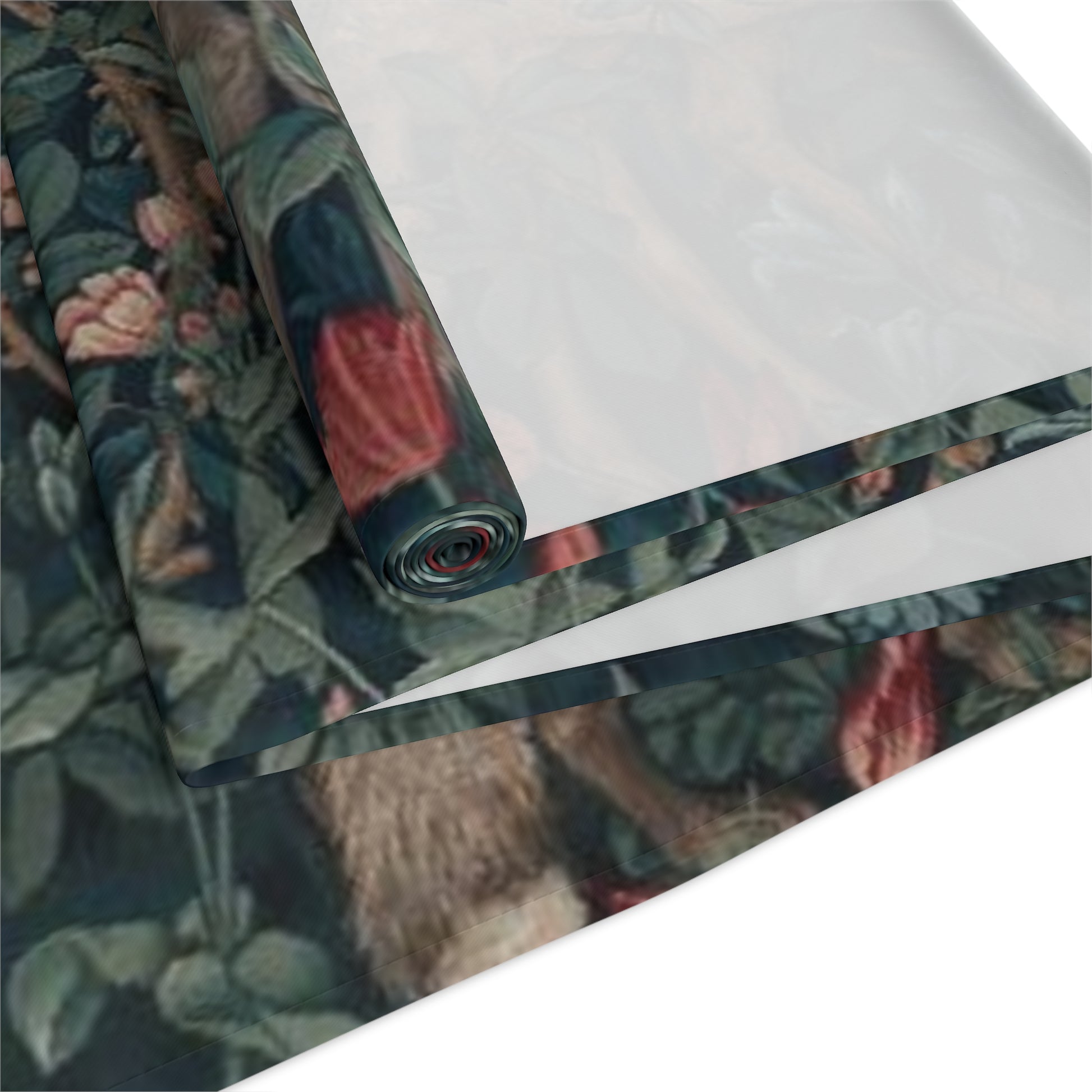 A table runner with a floral William Morris & Co pattern, featuring green leaves and pink flowers with a fox, dear and rabbit.