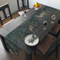 A table runner with a floral William Morris & Co pattern, featuring green leaves and pink flowers with a fox, dear and rabbit.