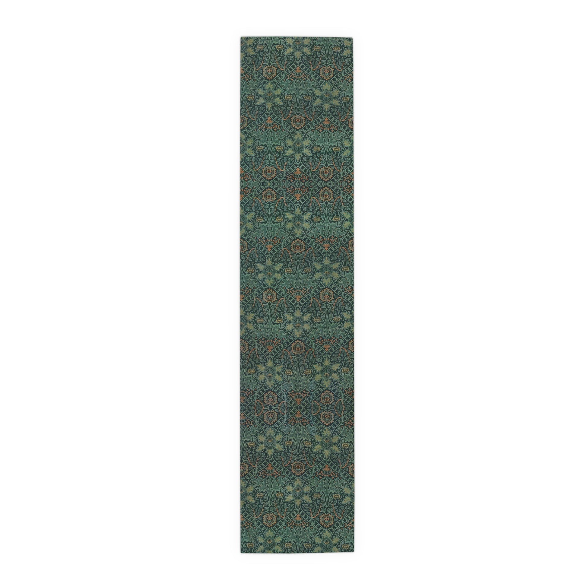 A green table runner with a floral pattern inspired by William Morris, displayed on a dining table with dishes and cutlery.