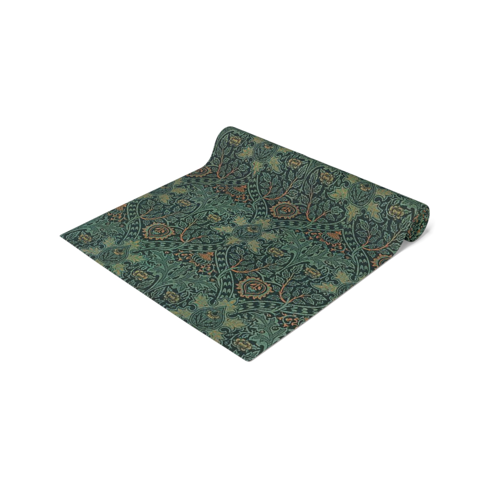 A green table runner with a floral pattern inspired by William Morris, displayed on a dining table with dishes and cutlery.