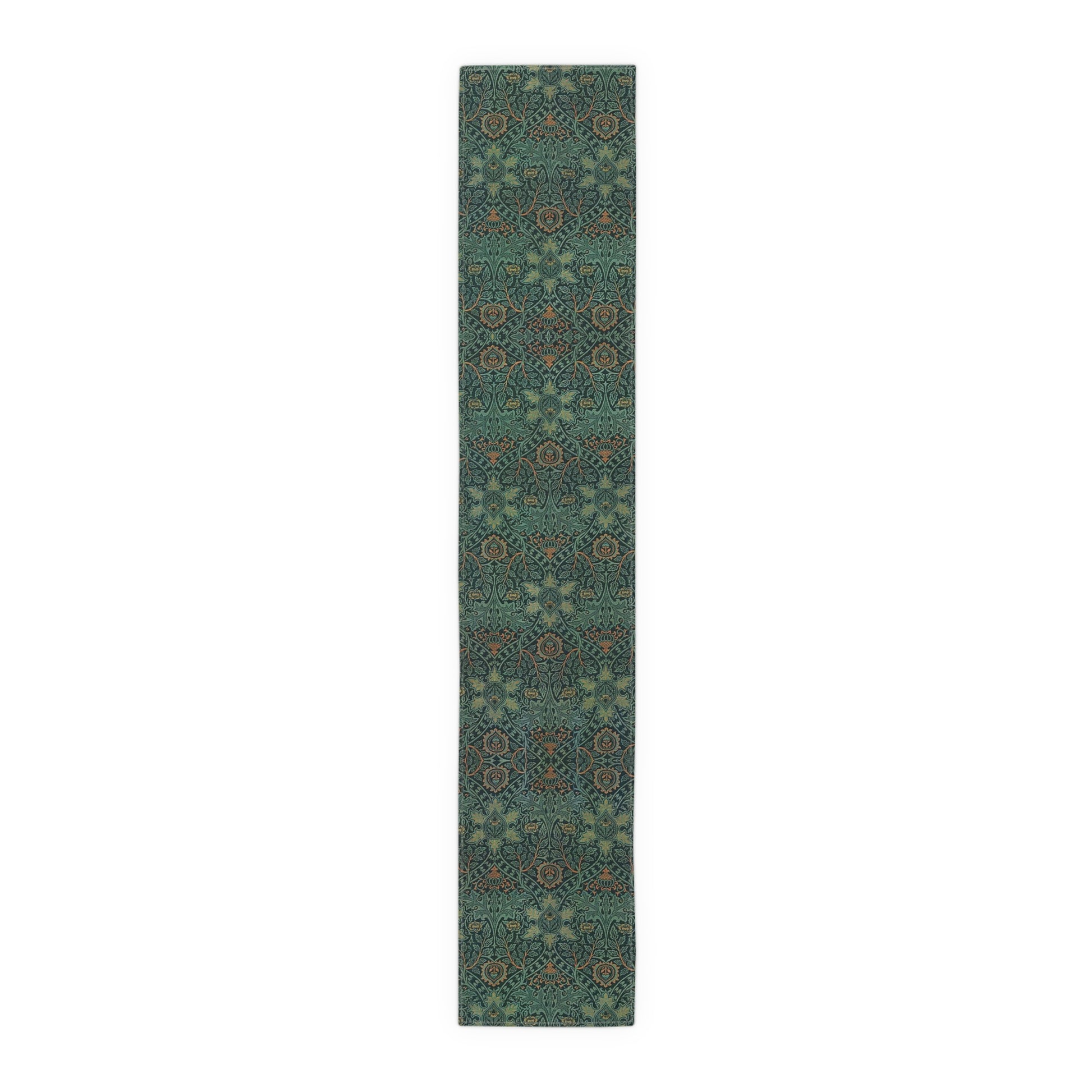 A green table runner with a floral pattern inspired by William Morris, displayed on a dining table with dishes and cutlery.