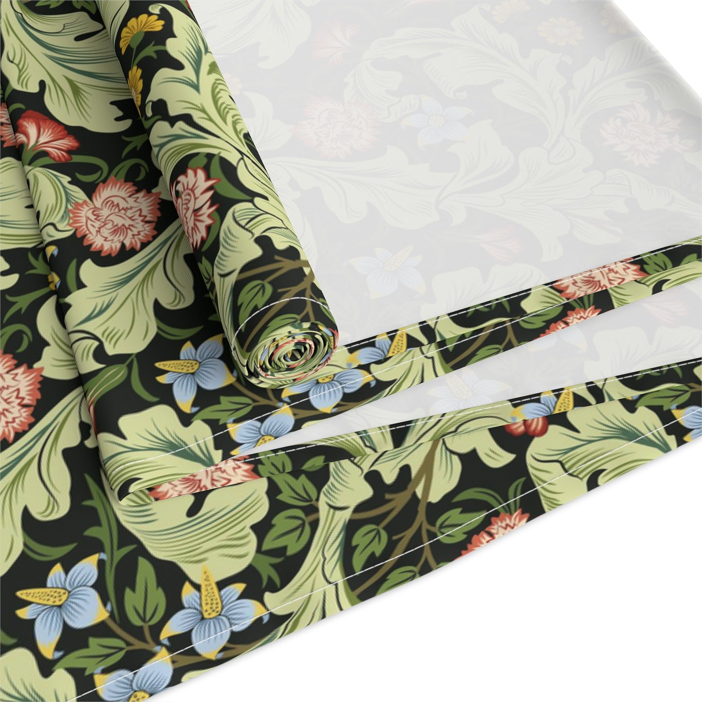 A green floral patterned table runner by William Morris & Co, Leicester Collection, displayed on a dining table.