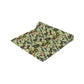 A green floral patterned table runner by William Morris & Co, Leicester Collection, displayed on a dining table.
