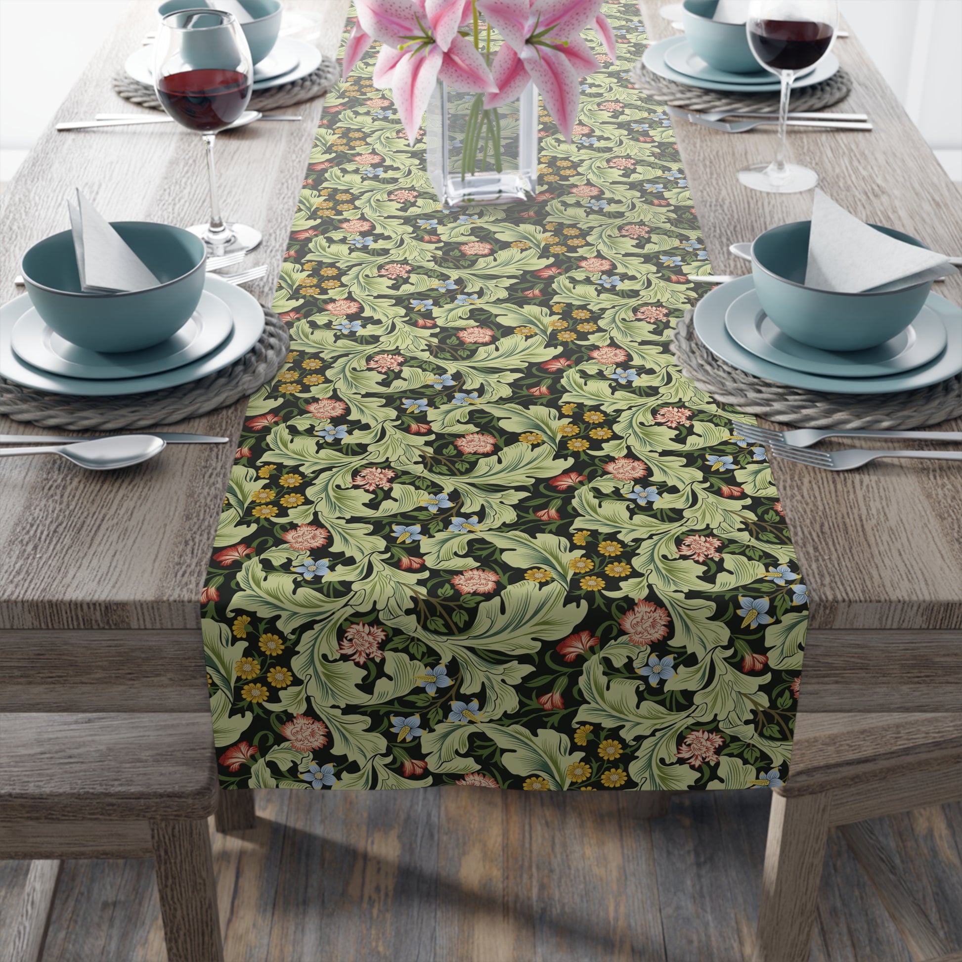 A green floral patterned table runner by William Morris & Co, Leicester Collection, displayed on a dining table.