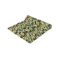 A green floral patterned table runner by William Morris & Co, Leicester Collection, displayed on a dining table.