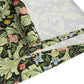 A green floral patterned table runner by William Morris & Co, Leicester Collection, displayed on a dining table.