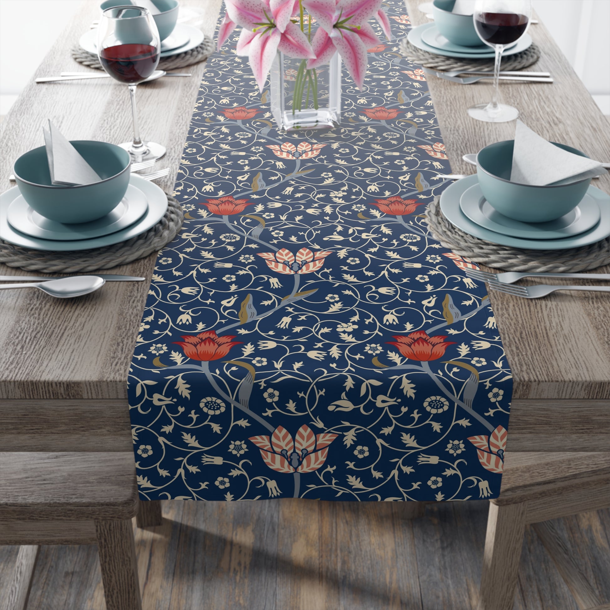 A table runner with a floral pattern in shades of red and blue, displayed on a dining table.