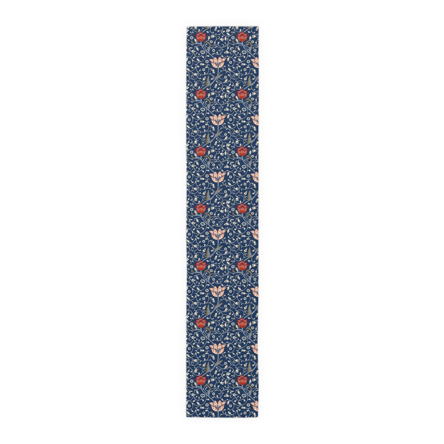 A William Morris & Co table runner with a floral pattern  called Medway in shades of red and blue, displayed on a dining table.