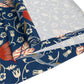 A William Morris & Co table runner with a floral pattern  called Medway in shades of red and blue, displayed on a dining table.