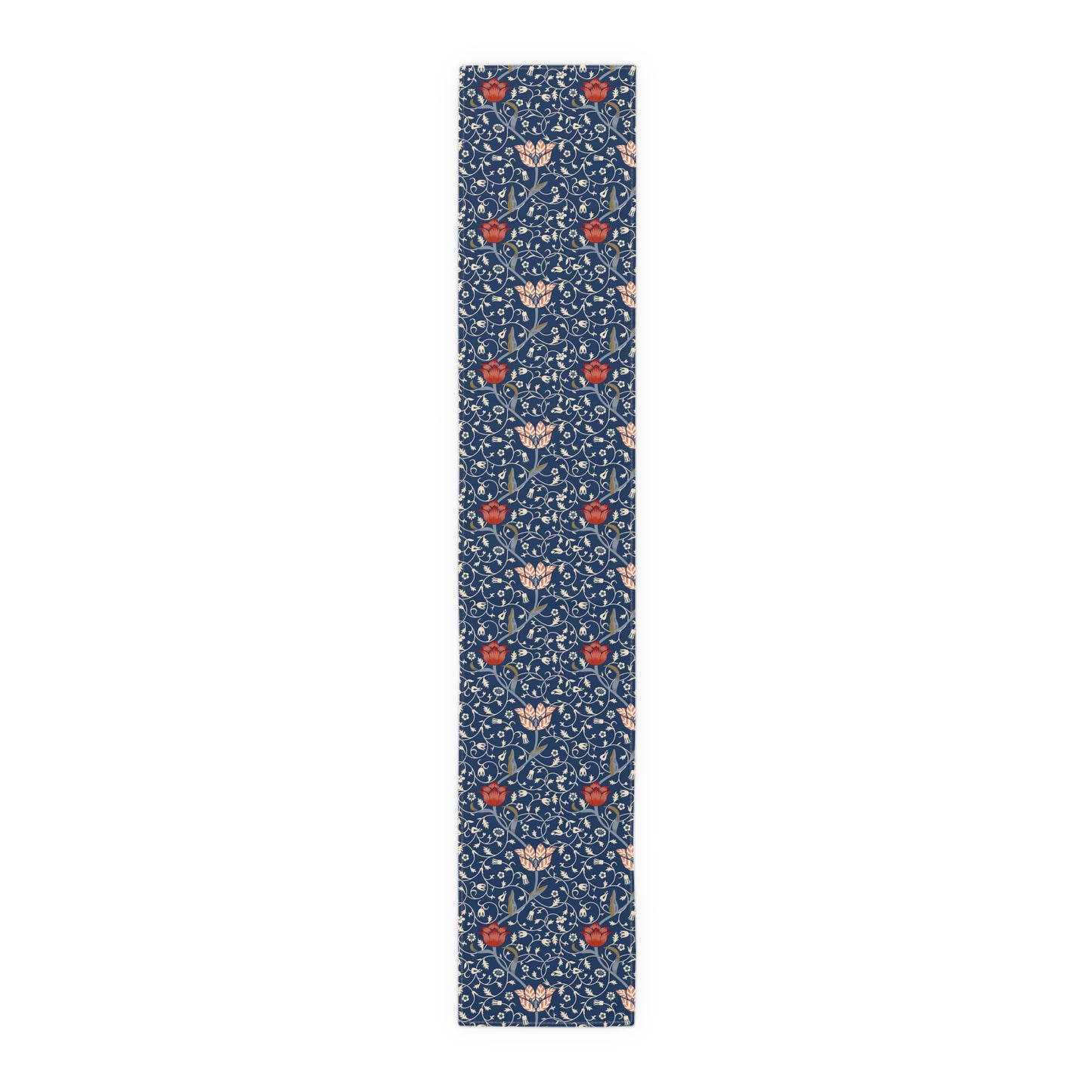 A William Morris & Co table runner with a floral pattern  called Medway in shades of red and blue, displayed on a dining table.