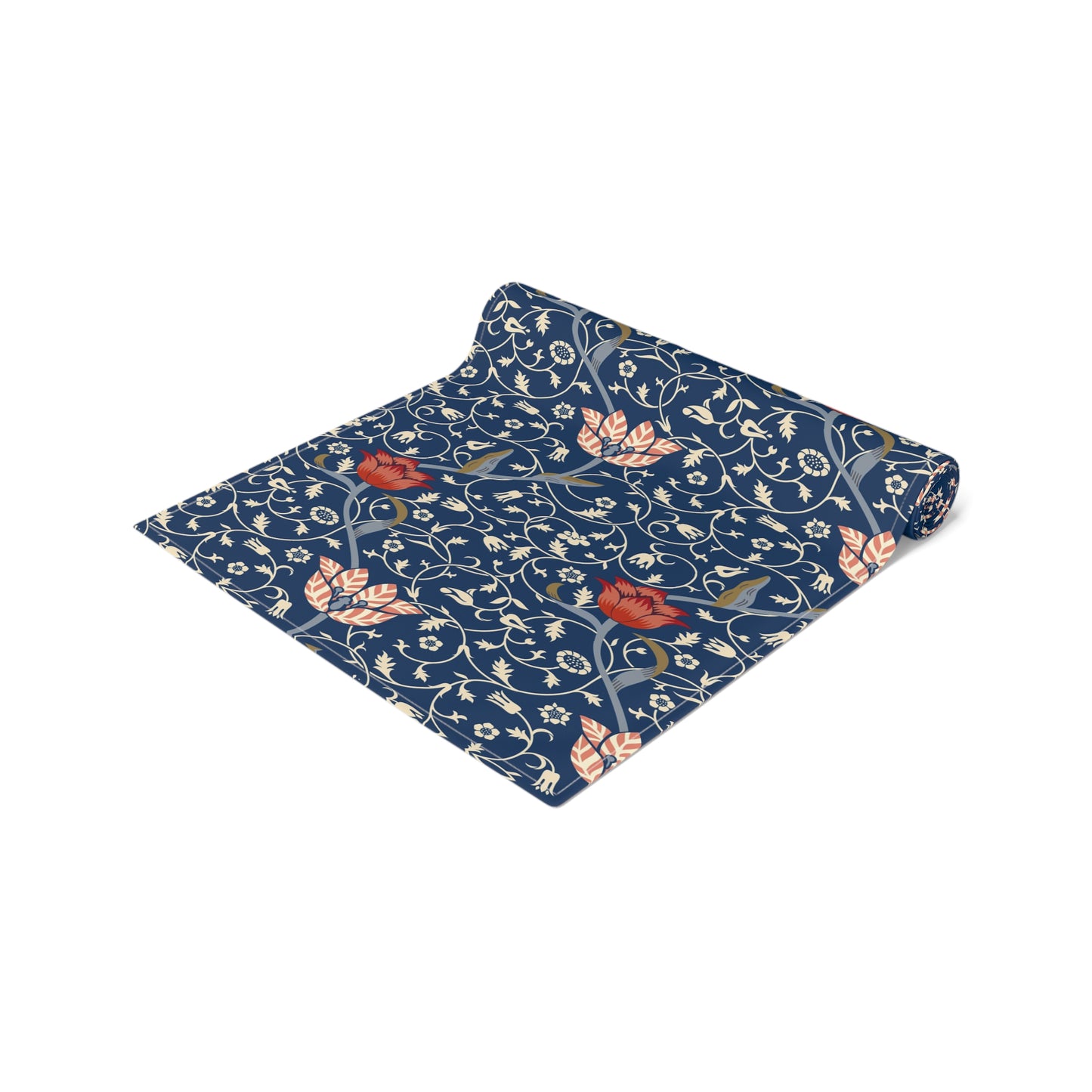 A William Morris & Co table runner with a floral pattern  called Medway in shades of red and blue, displayed on a dining table.
