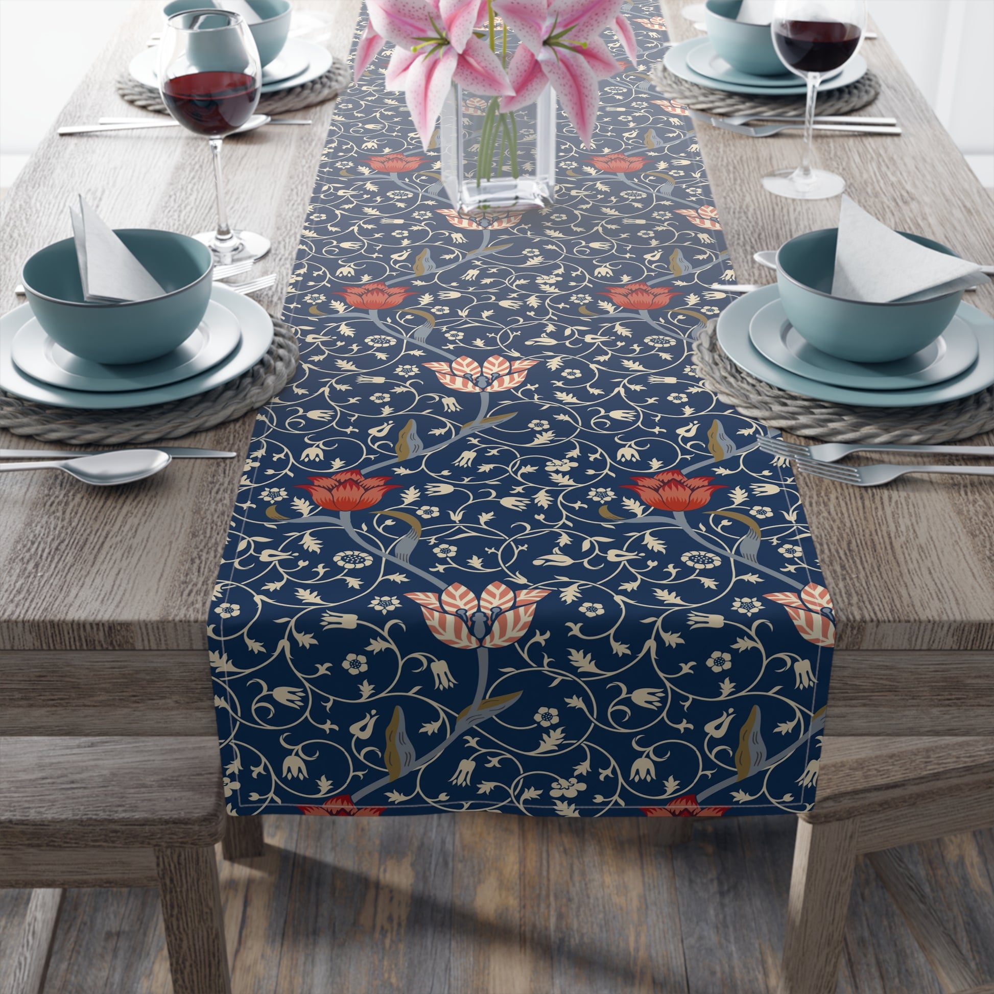 A table runner with a floral pattern in shades of red and blue, displayed on a dining table.