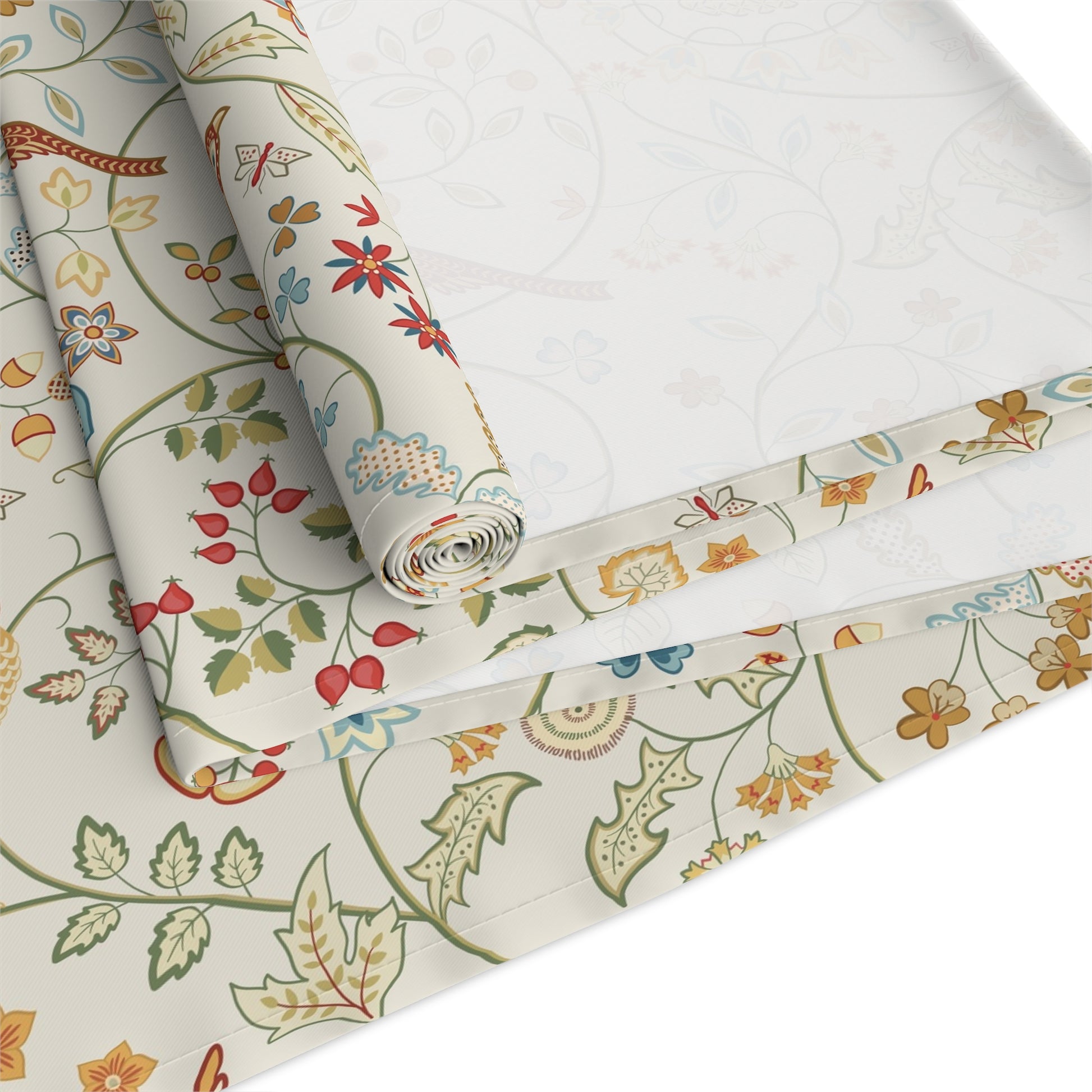 Roll of floral-patterned fabric with colorful designs on a white background