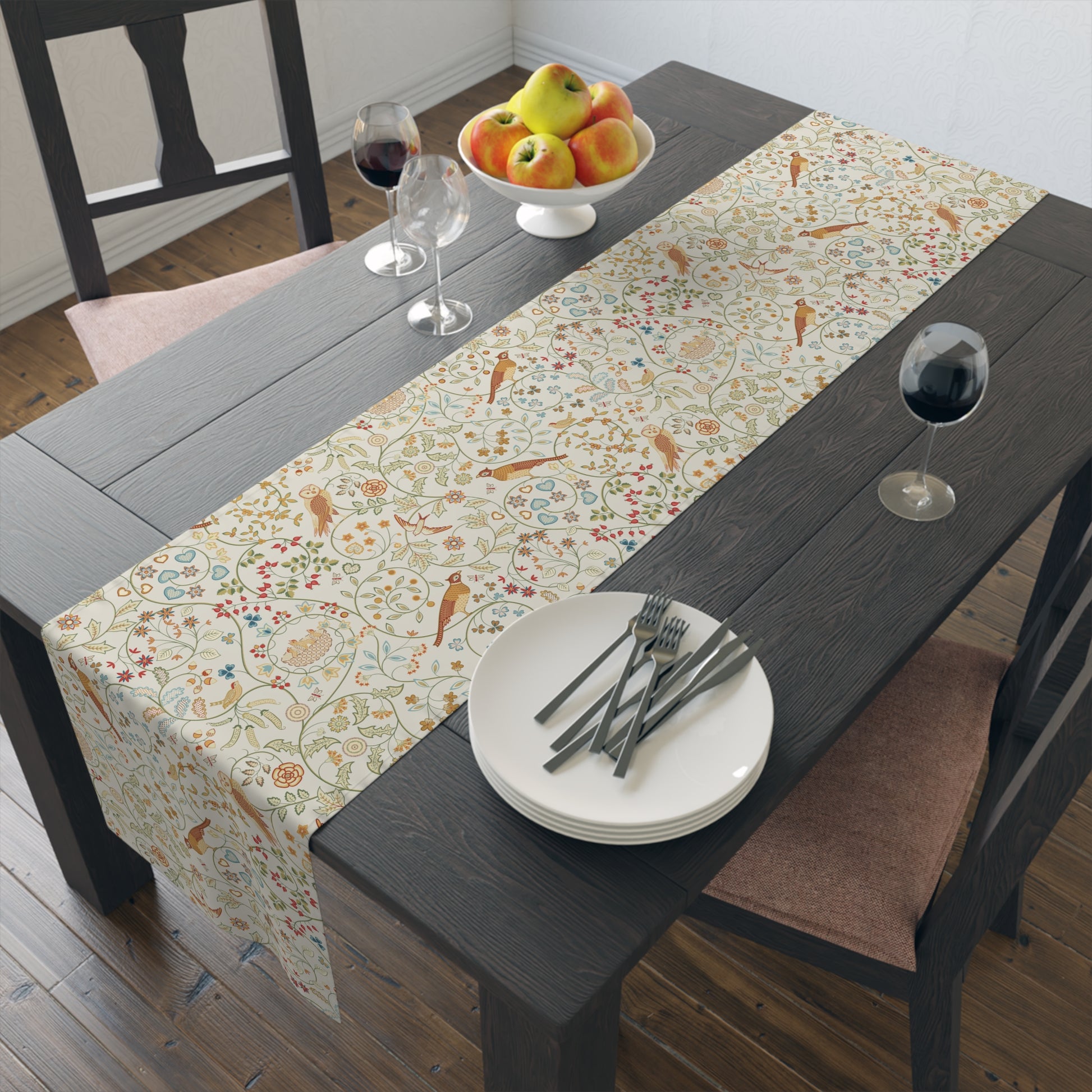 Dining table with a patterned table runner, plates, cutlery, and fruit bowl.