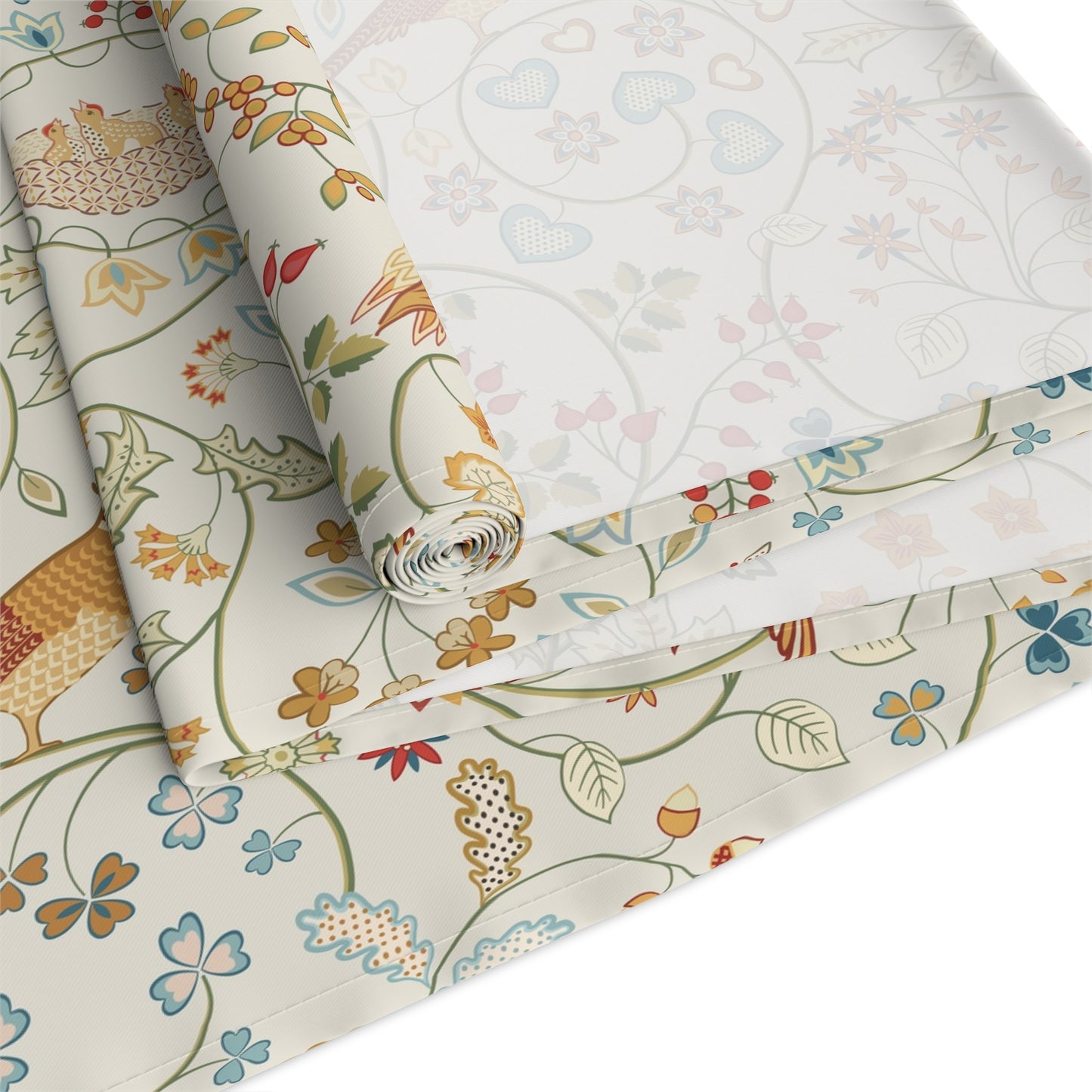 Roll of floral-patterned fabric with colorful designs on a white background
