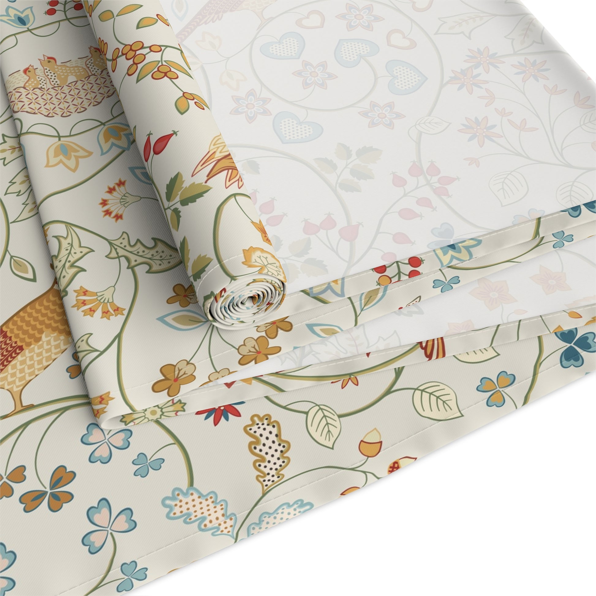 Roll of floral-patterned fabric with colorful designs on a white background