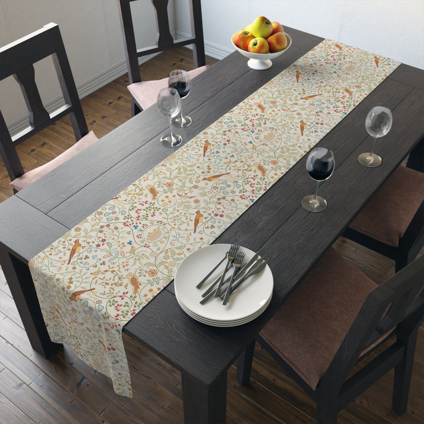 Dining table with a patterned table runner, plates, and glasses in a room.