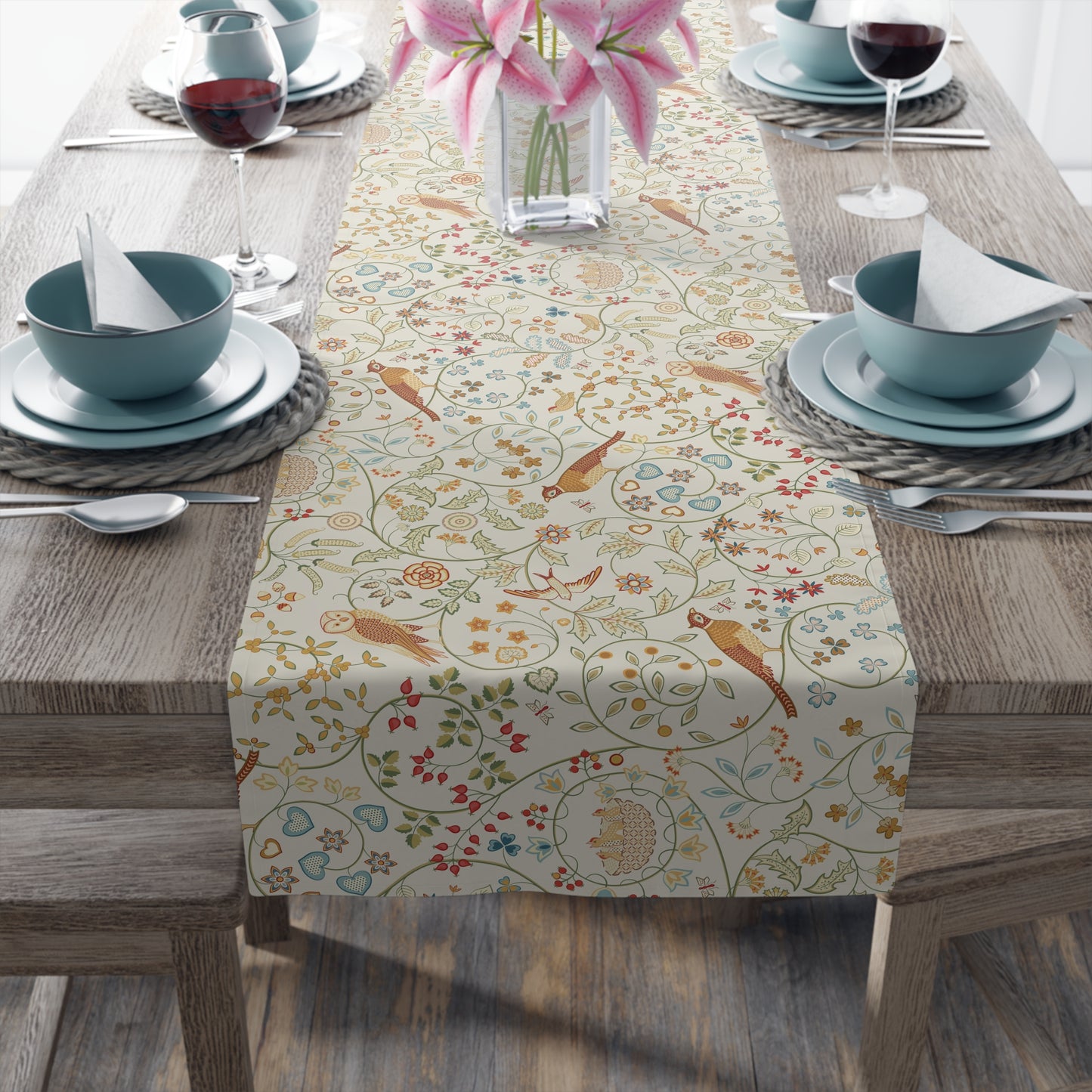 Dining table with a patterned table runner, bowls, and glasses on a wooden table.
