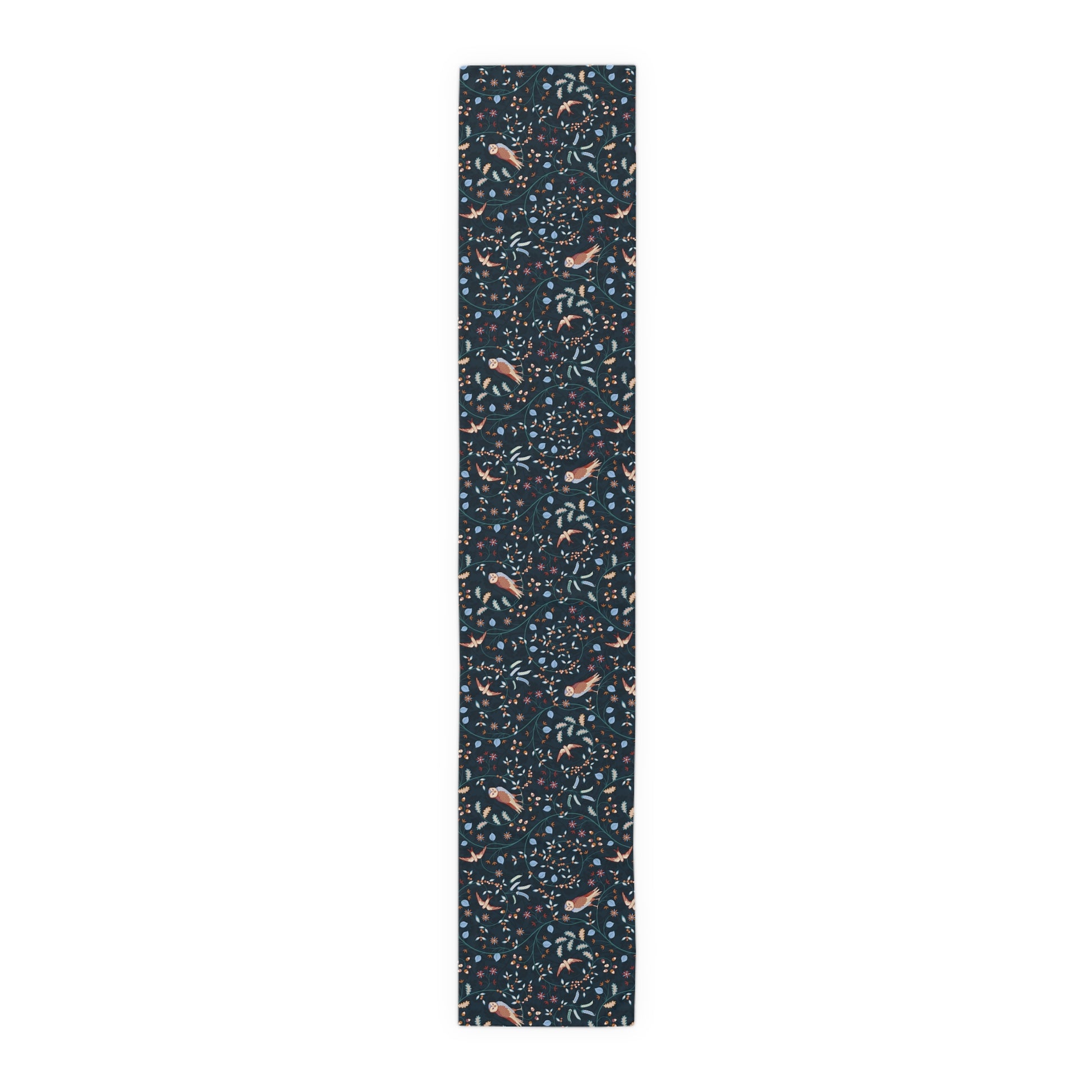Table runner with a pattern of small, colourful designs on a dark blue background