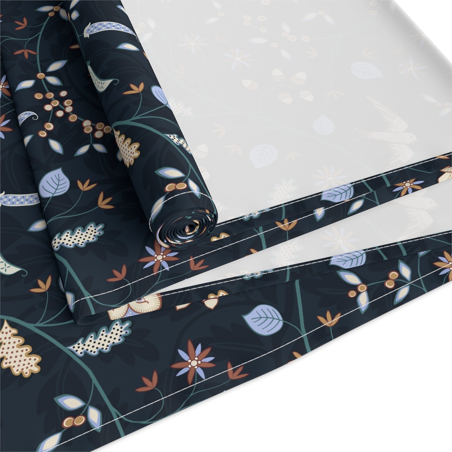 Roll of fabric with floral pattern on a white background