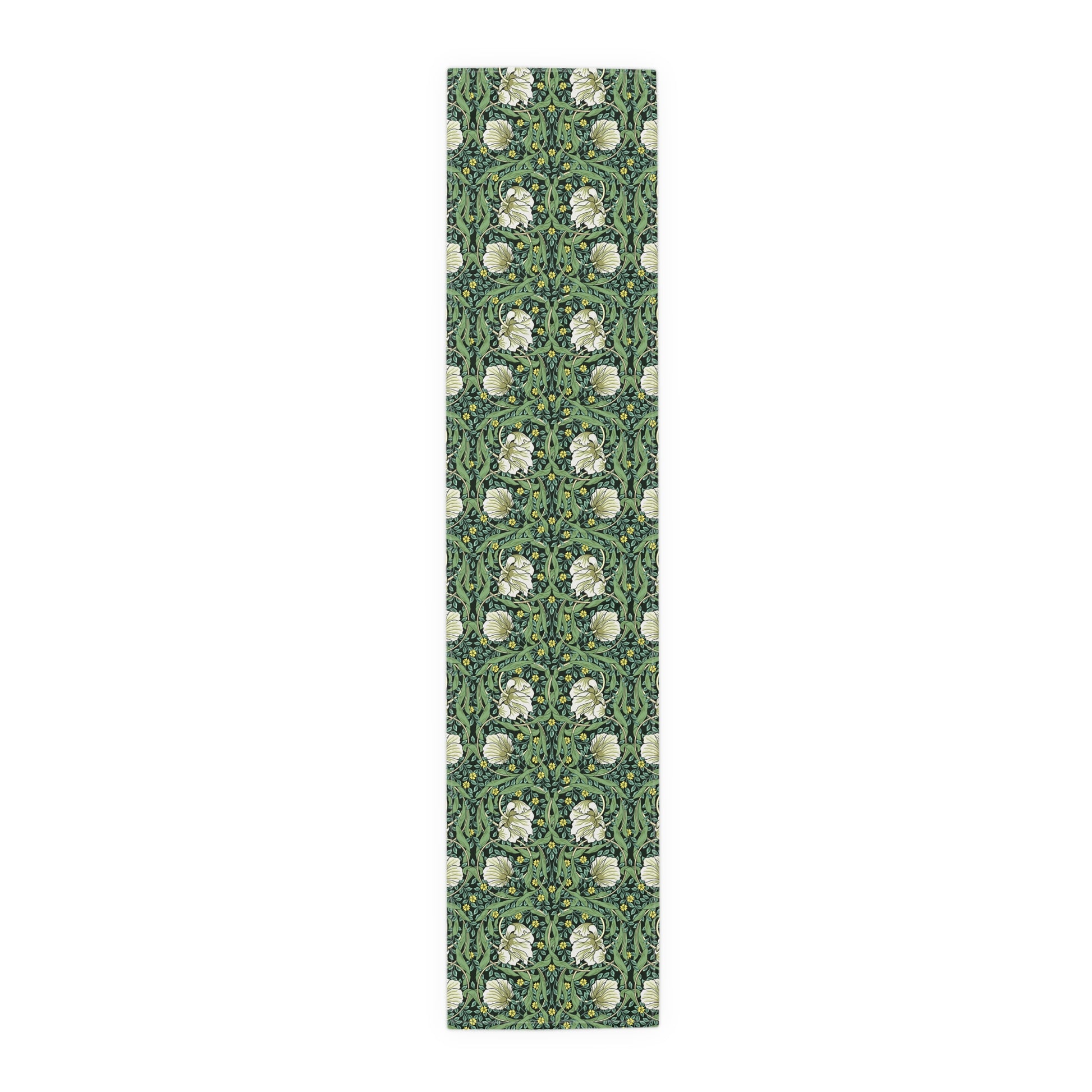 A green table runner with a floral William Morris & Co pattern displayed on a dining table.