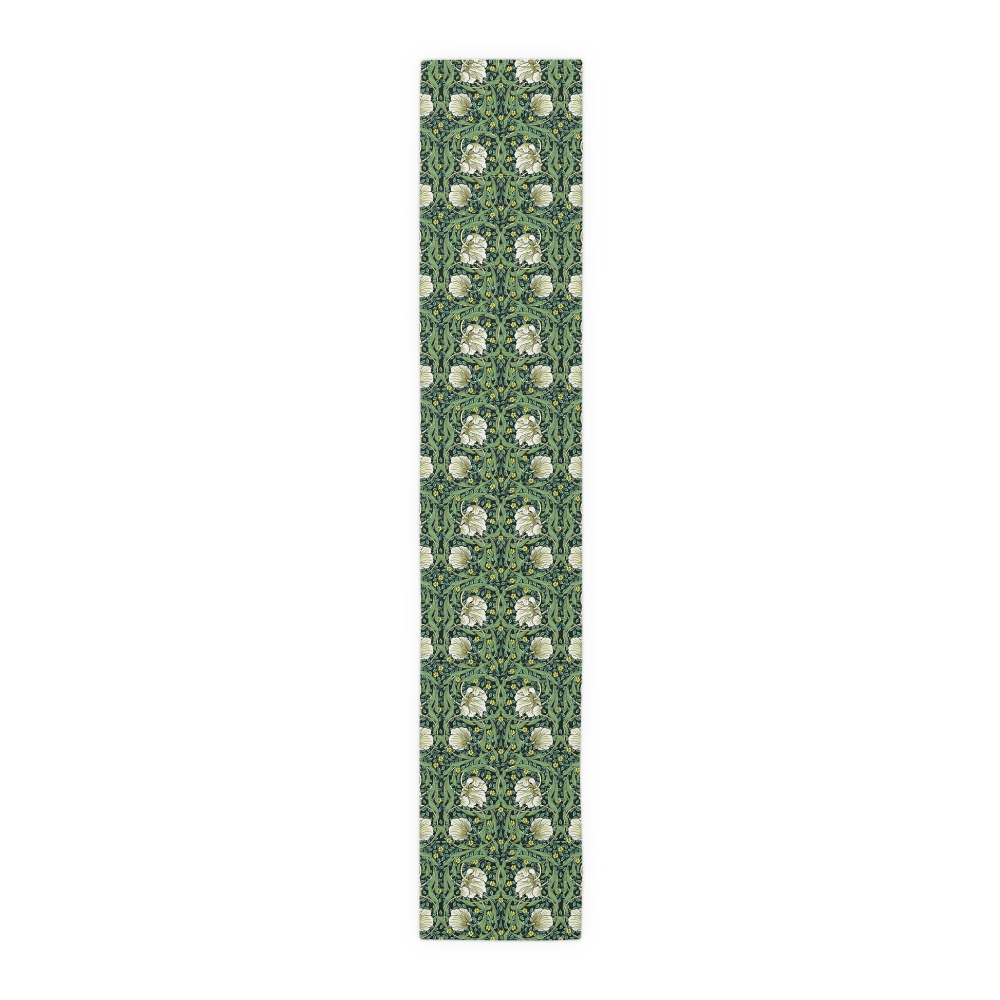 A green table runner with a floral William Morris & Co pattern displayed on a dining table.