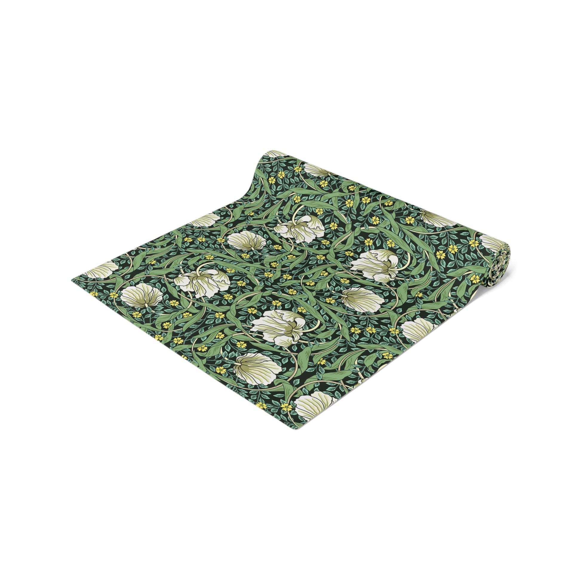 A green table runner with a floral William Morris & Co pattern displayed on a dining table.