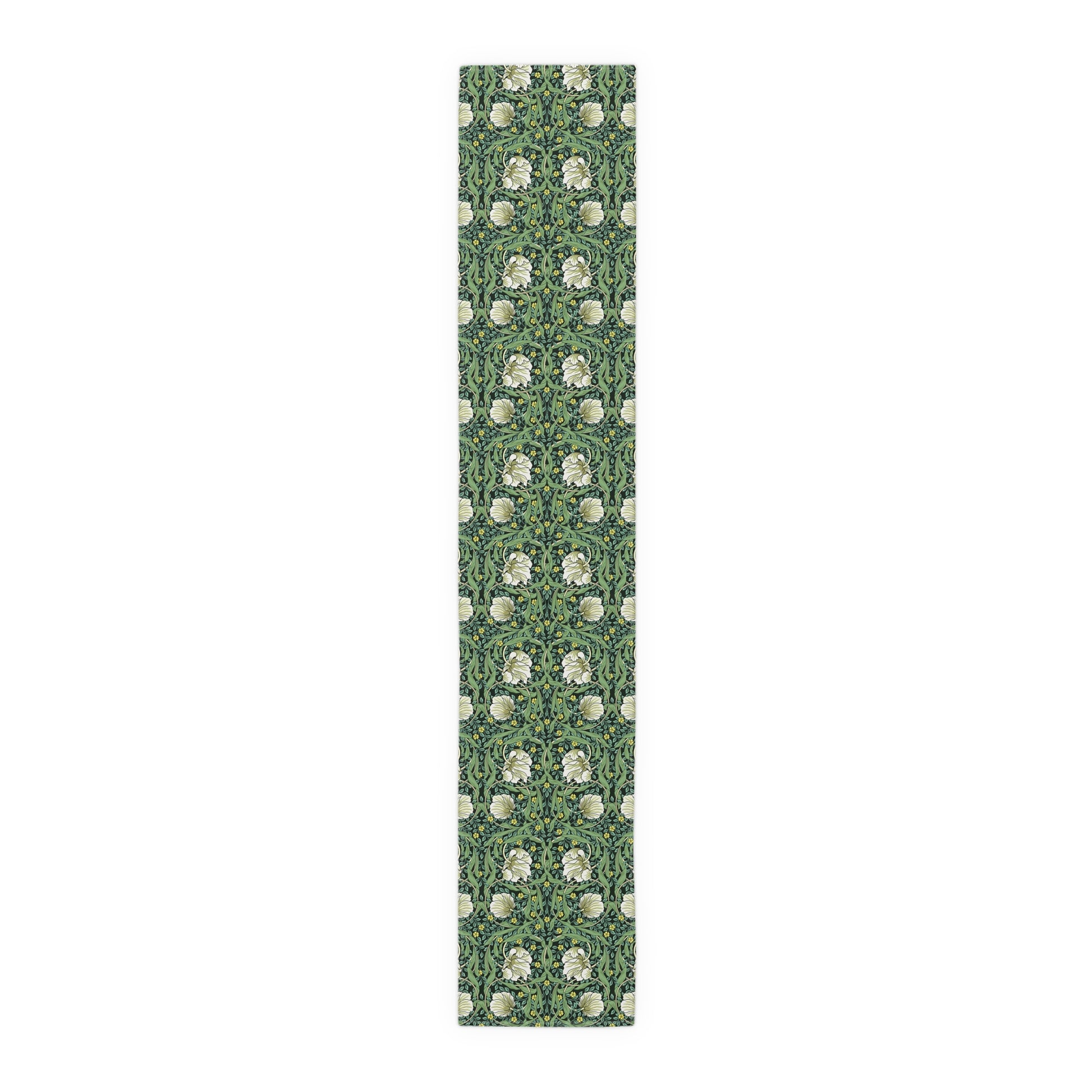 A green table runner with a floral William Morris & Co pattern displayed on a dining table.
