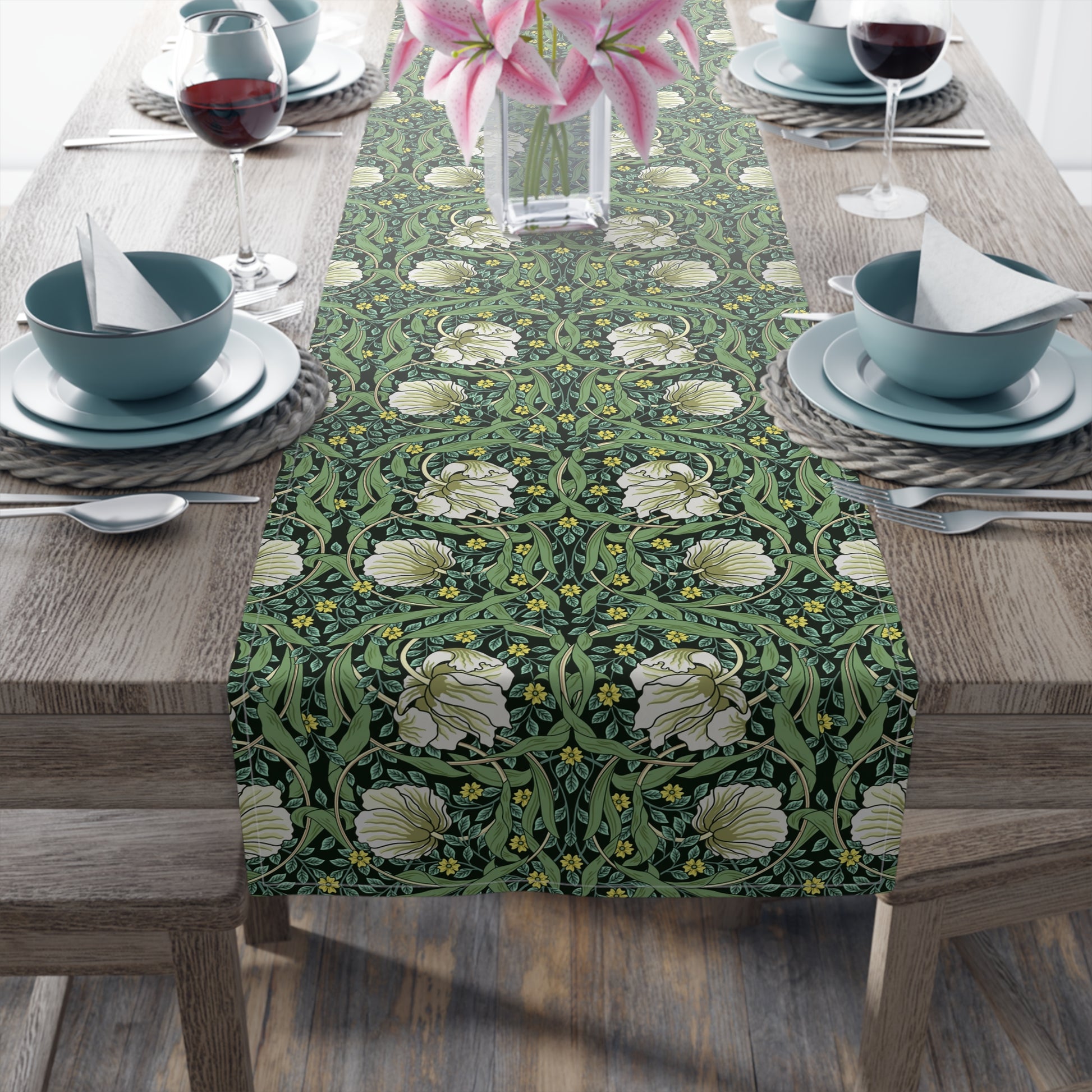 A green table runner with a floral William Morris & Co pattern displayed on a dining table.