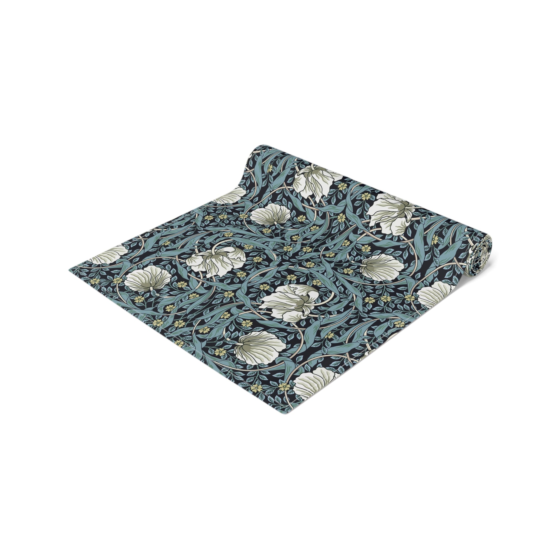 A table runner with a floral William Morris & Co pattern in slate colour laid out on a dining table.