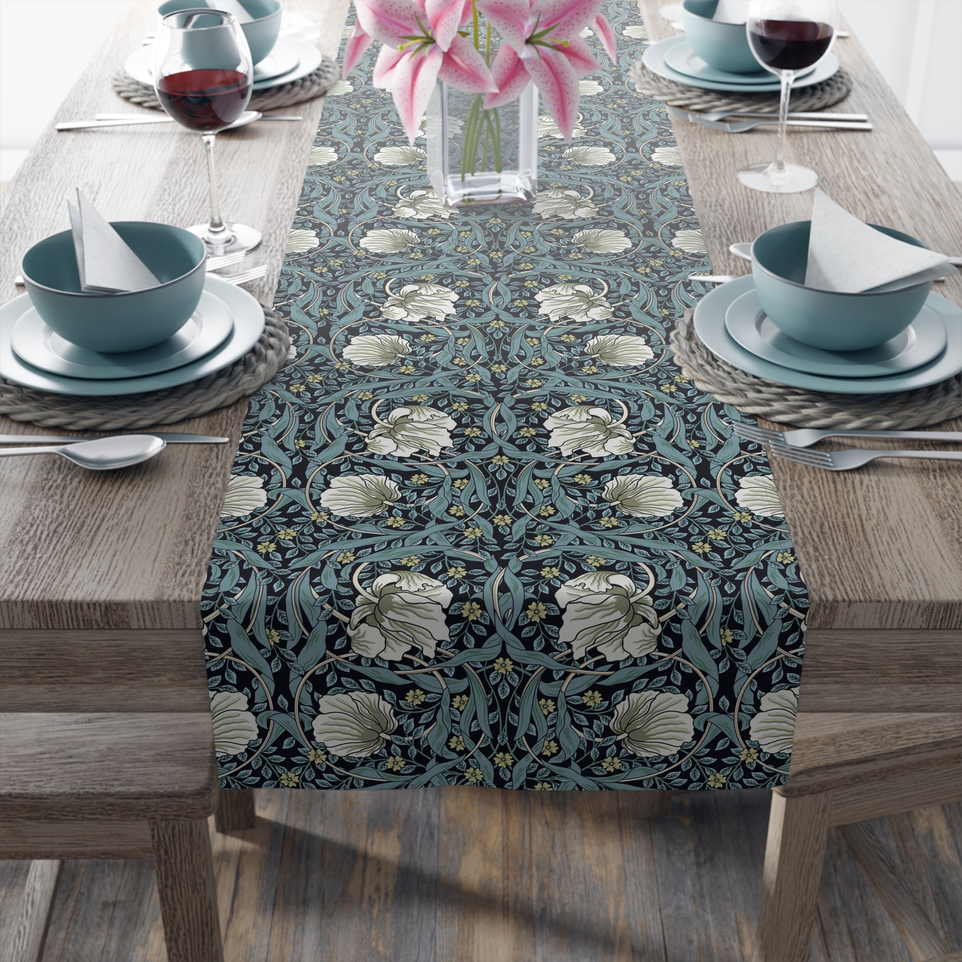 A table runner with a floral pattern in slate color laid out on a dining table.