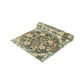 A table runner with a floral pattern inspired by William Morris, displayed on a dining table set with dishes and glasses.