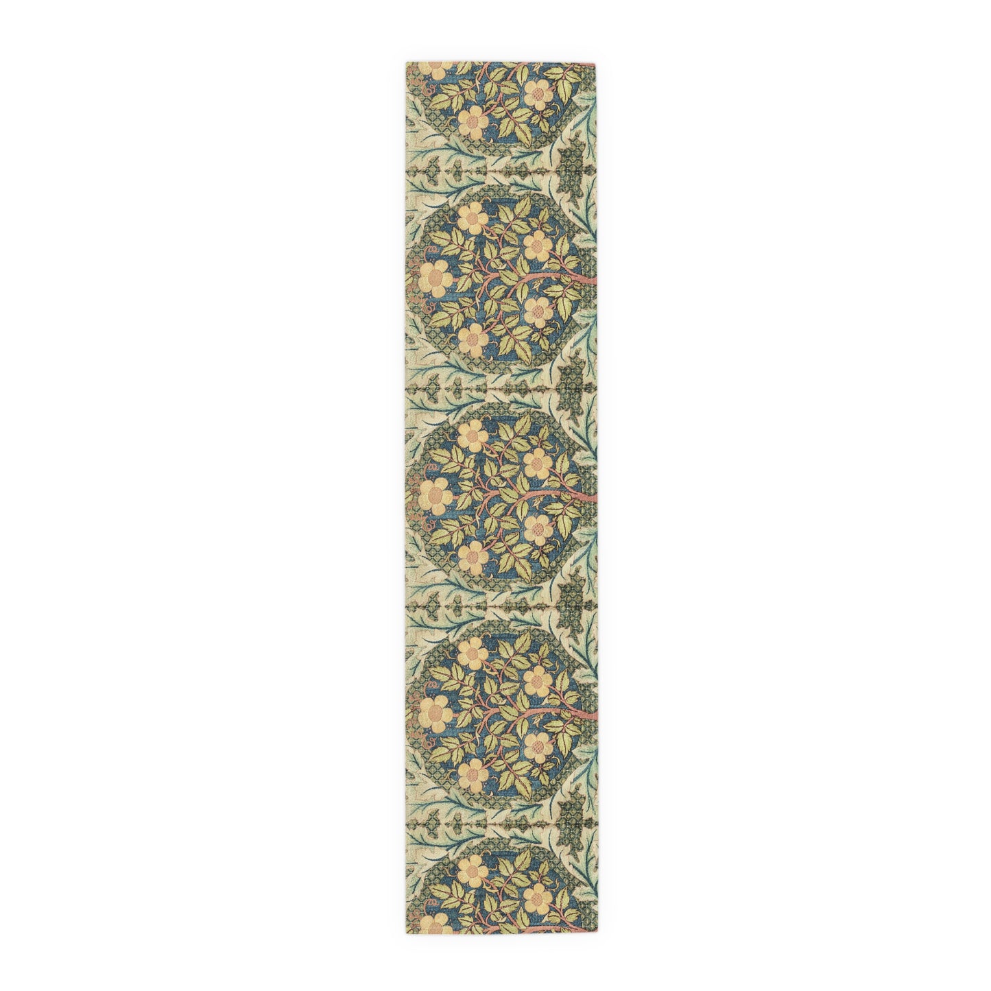 A table runner with a floral pattern inspired by William Morris, displayed on a dining table set with dishes and glasses.