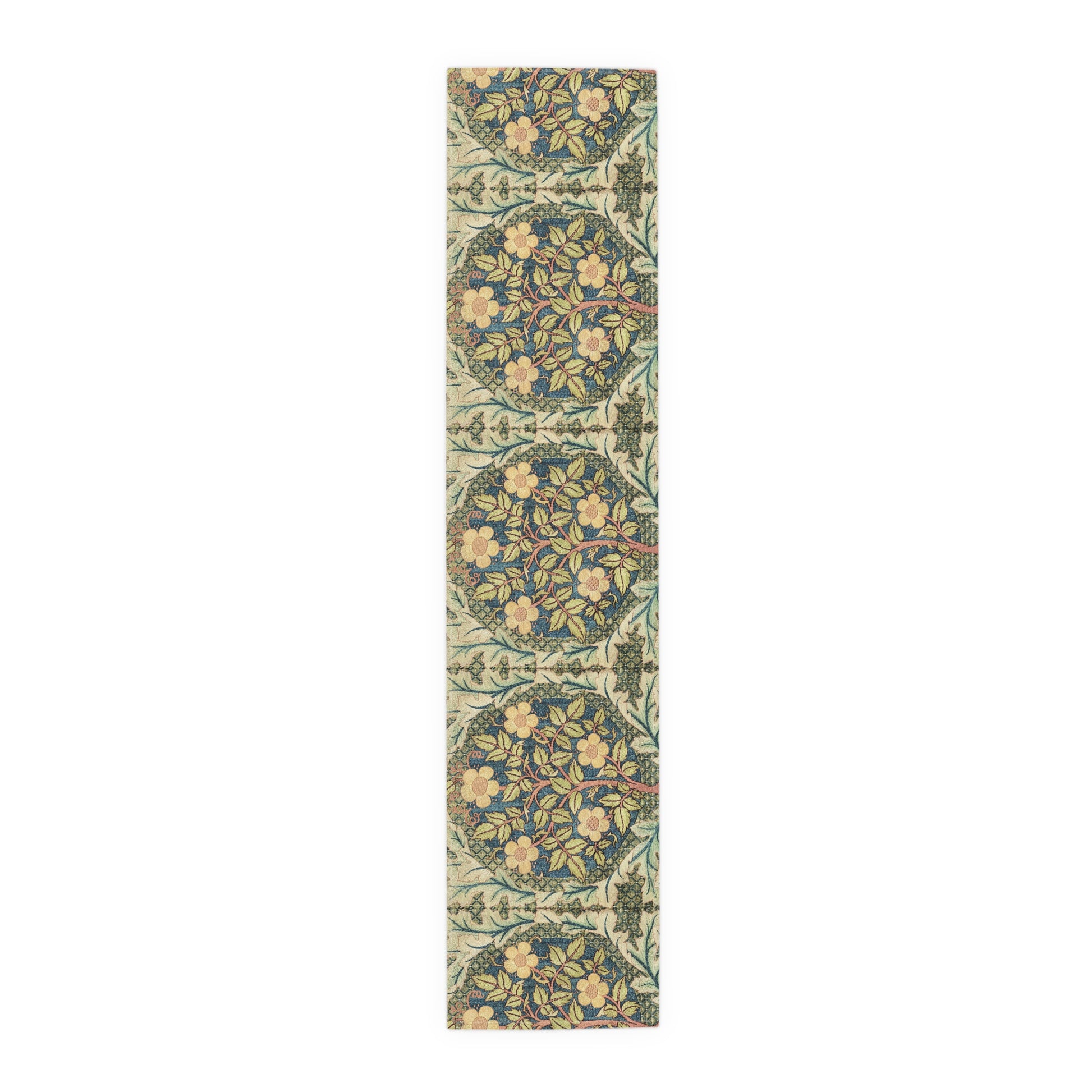A table runner with a floral pattern inspired by William Morris, displayed on a dining table set with dishes and glasses.