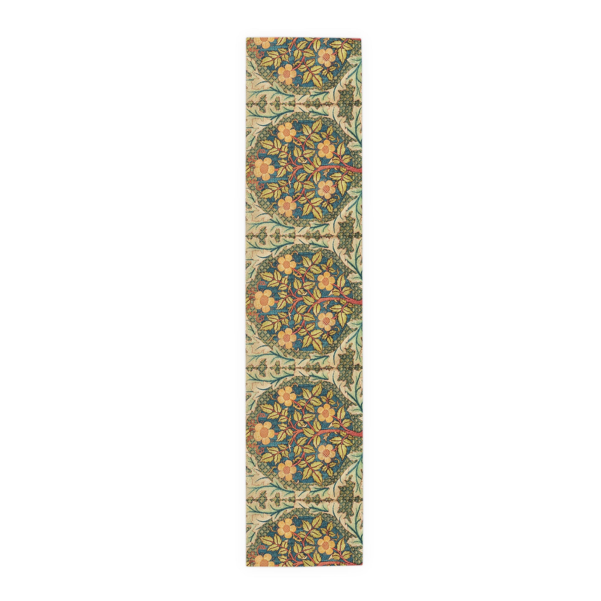 A table runner with a floral pattern inspired by William Morris, displayed on a dining table set with dishes and glasses.