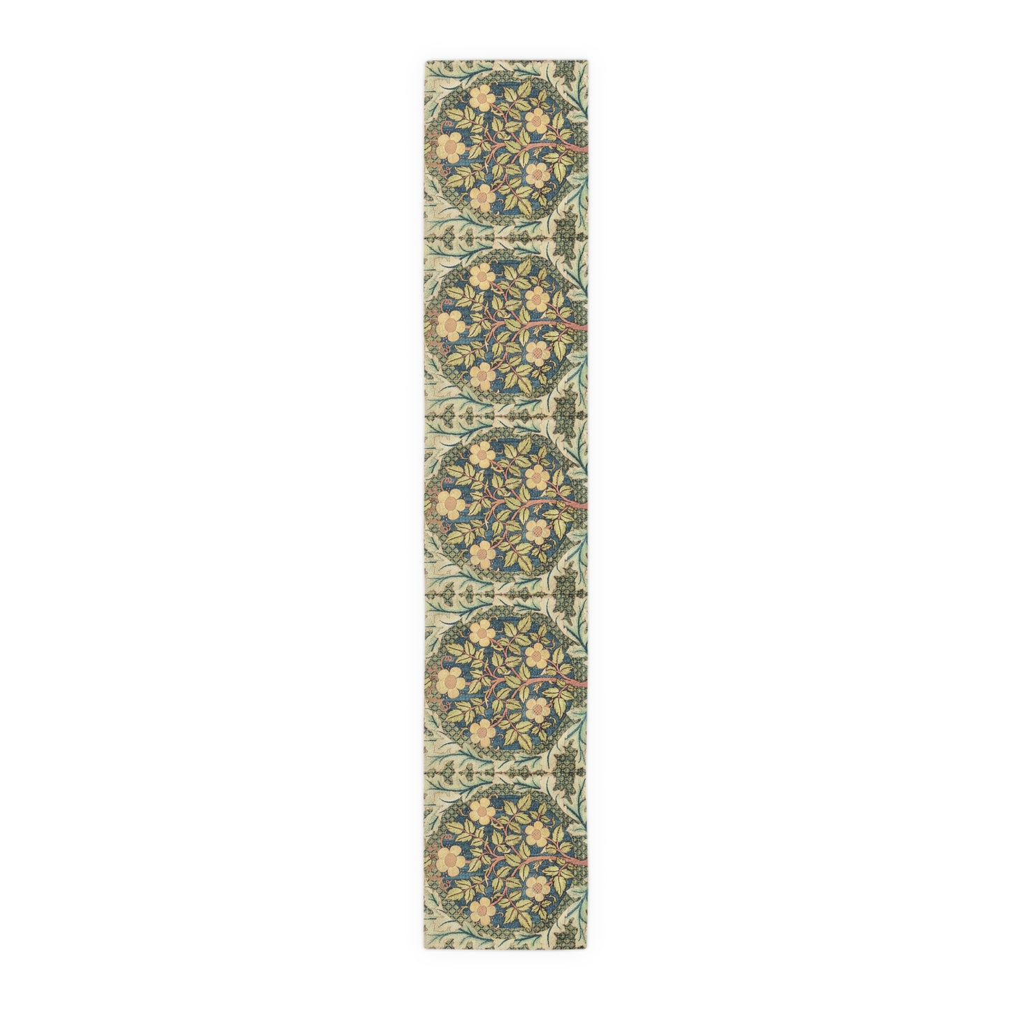 A table runner with a floral pattern inspired by William Morris, displayed on a dining table set with dishes and glasses.