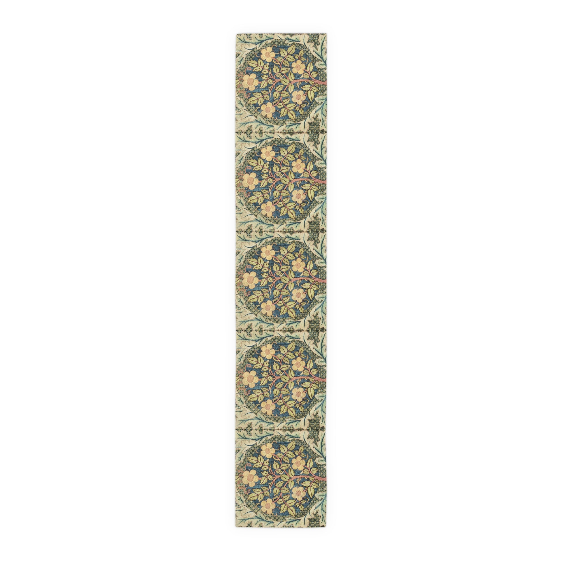 A table runner with a floral pattern inspired by William Morris, displayed on a dining table set with dishes and glasses.