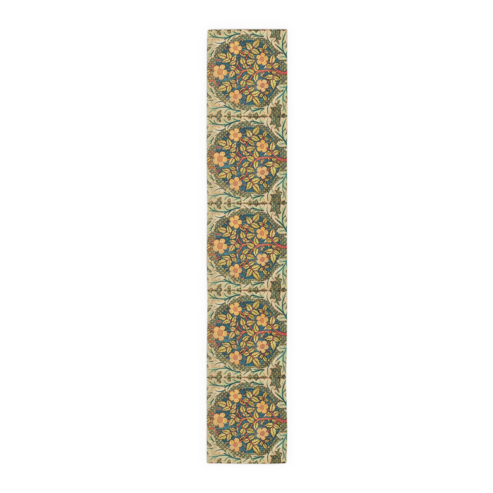 A table runner with a floral pattern inspired by William Morris, displayed on a dining table set with dishes and glasses.