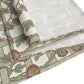 Roll of floral-patterned wallpaper with a wooden ladder on a white background