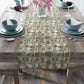 Dining table set with a floral-patterned table runner, bowls, and glasses.