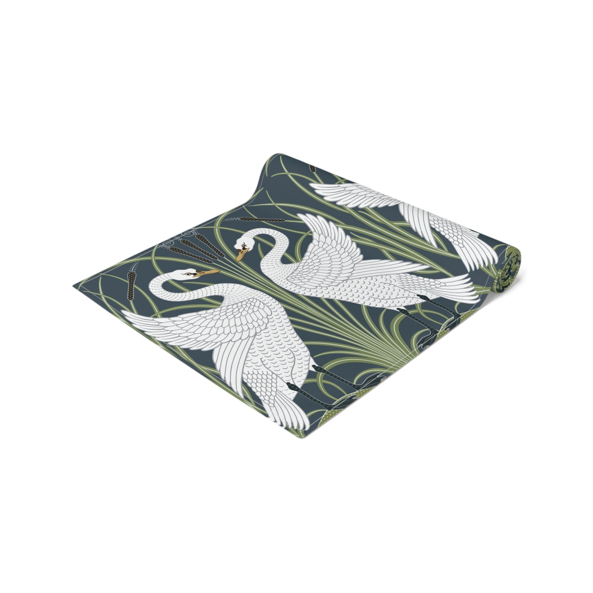 Folded fabric with swan and leaf pattern on a white background