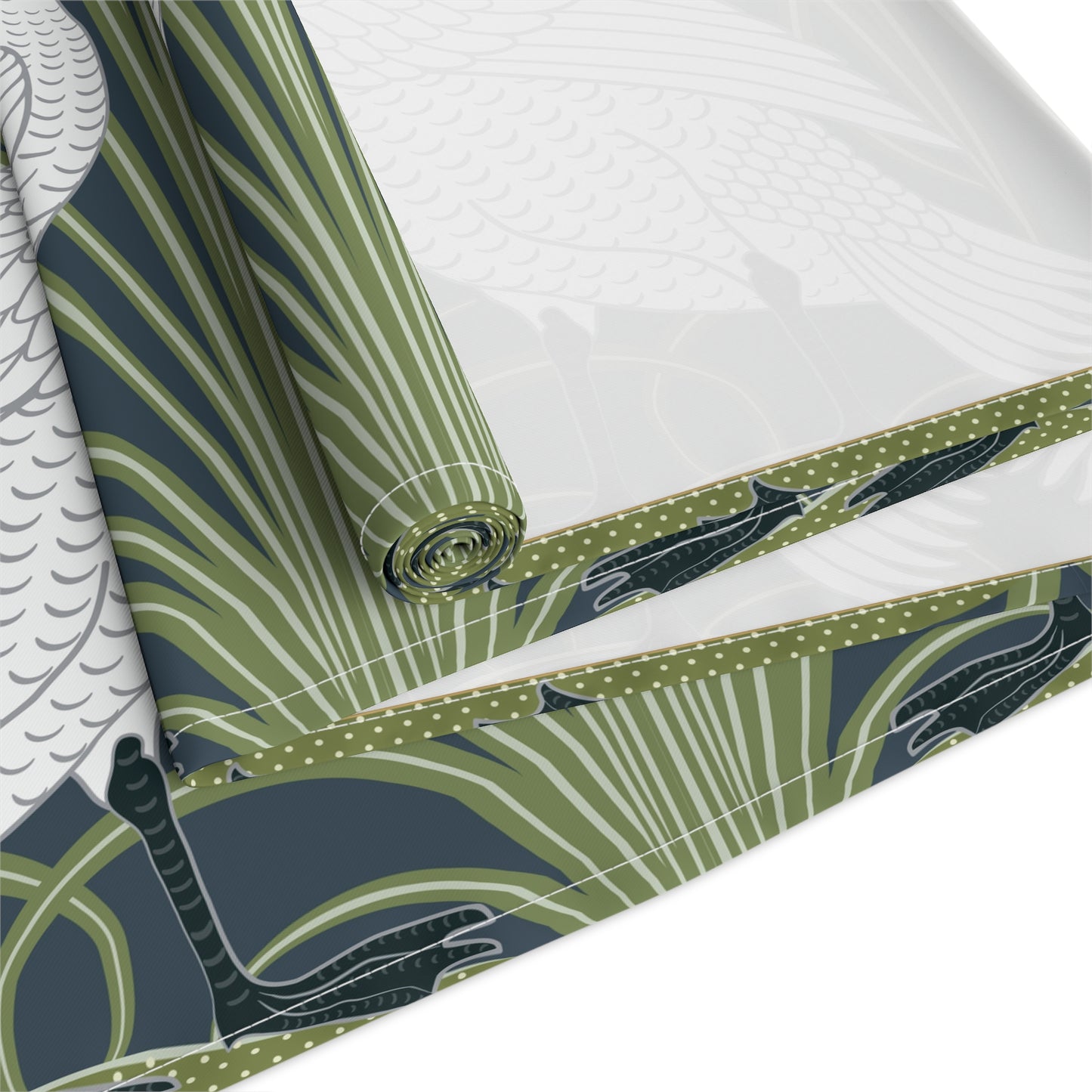 Roll of green and white patterned fabric with a bird design on a white background