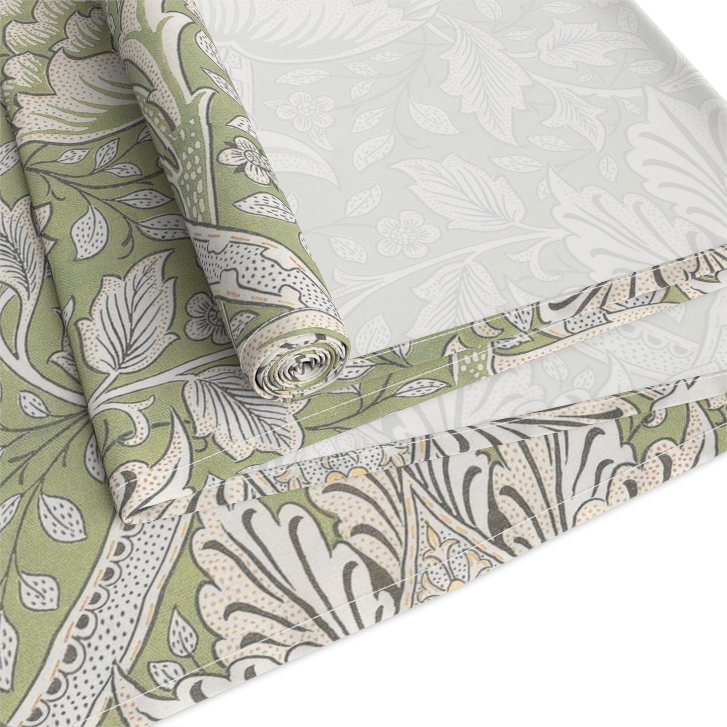 Roll of green and white floral patterned fabric on a white background