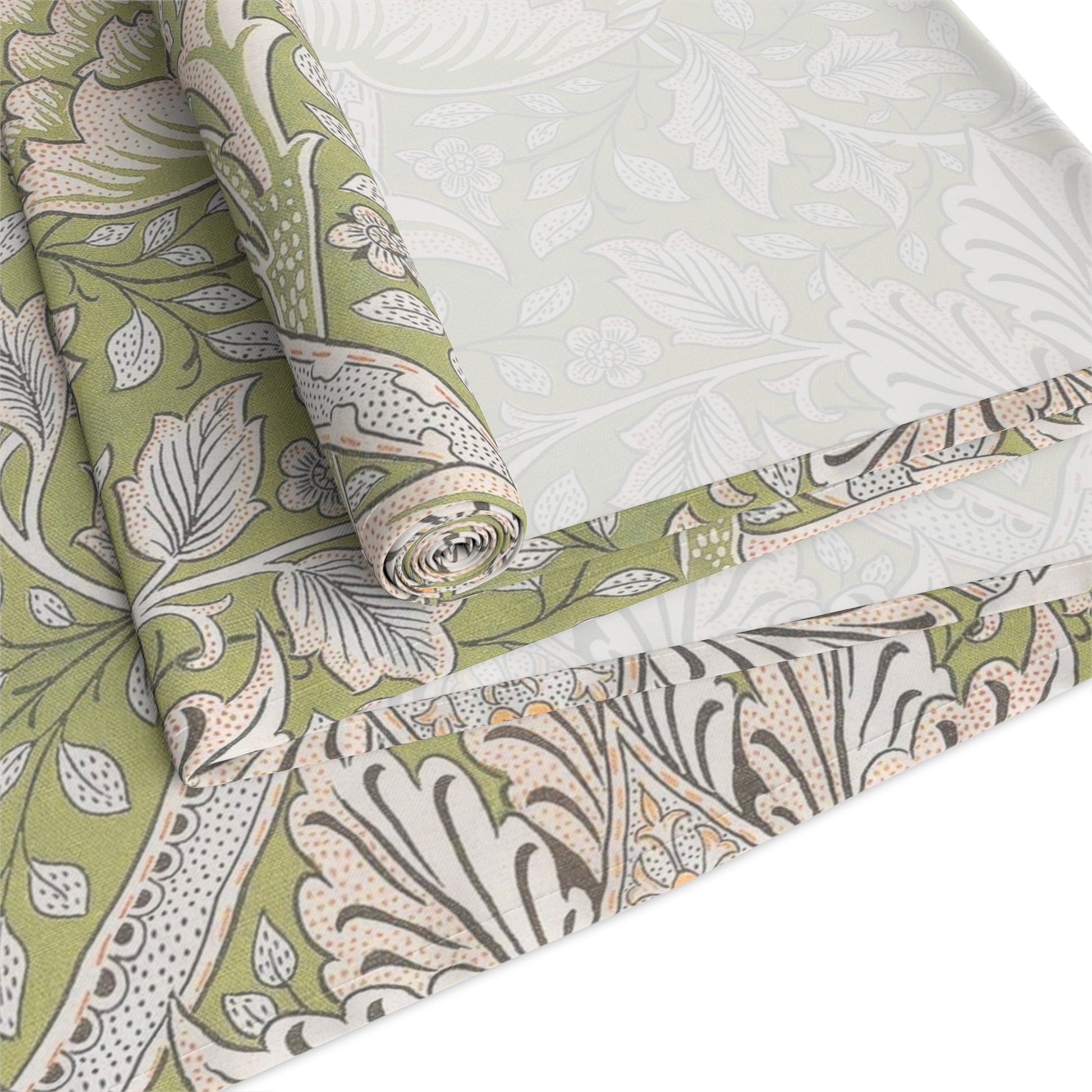 Roll of green and white floral patterned fabric on a white background
